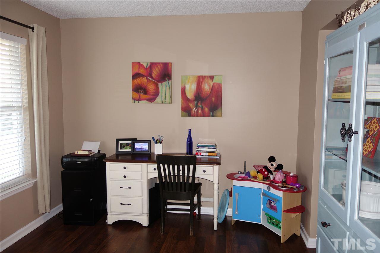 3921 Hopper Street Raleigh, NC 27616 - Photo 8 of 24 a bedroom with a bed and wooden floor