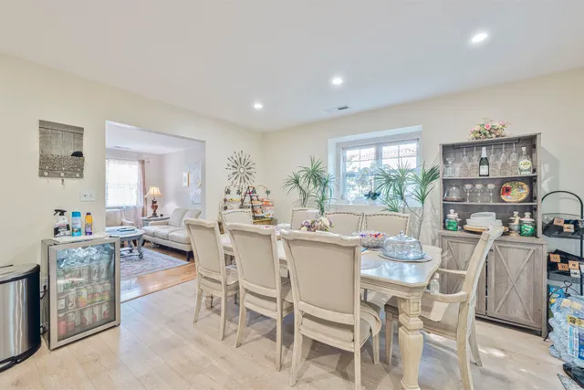 a dining room with furniture and a floor to ceiling window