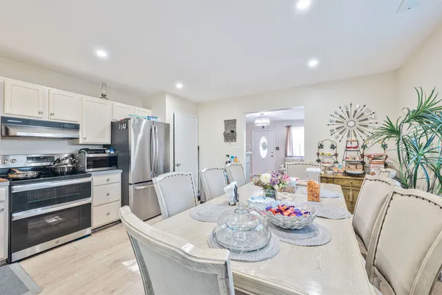 a living room with furniture and kitchen view