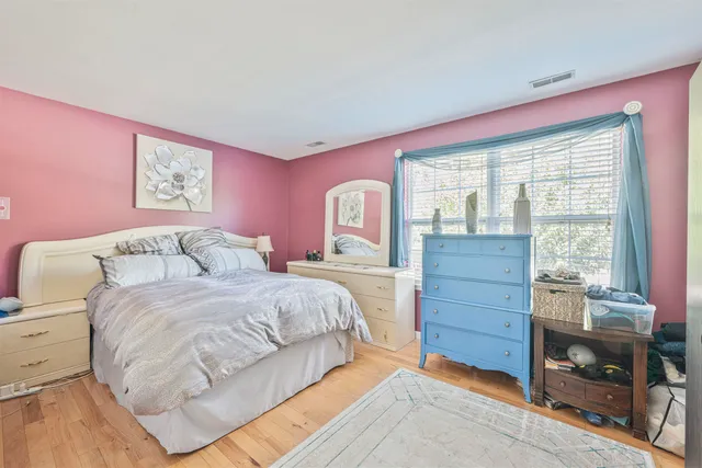 a bedroom with a bed and a dresser