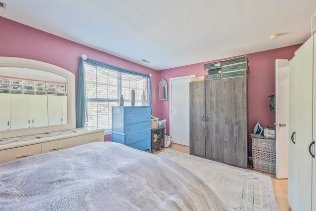 a spacious bedroom with a large bed and a large window