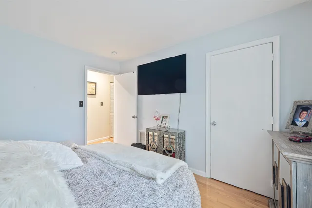 a bedroom with a bed and a flat screen tv