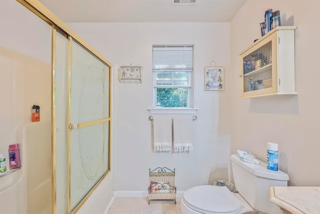 a white toilet sitting next to a bathroom sink