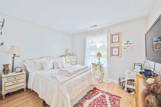 a bed room with a bed and a chair