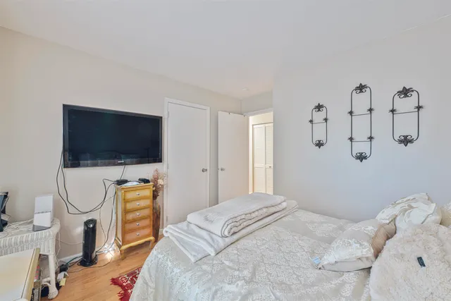 a bedroom with a bed and a flat screen tv