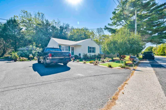 a front view of a house with a yard and sitting area