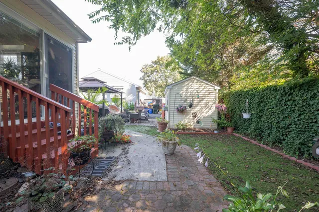 a view of backyard with outdoor seating and trees