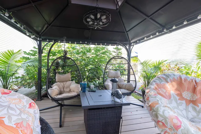 a view of a patio with couches chairs and a potted plant