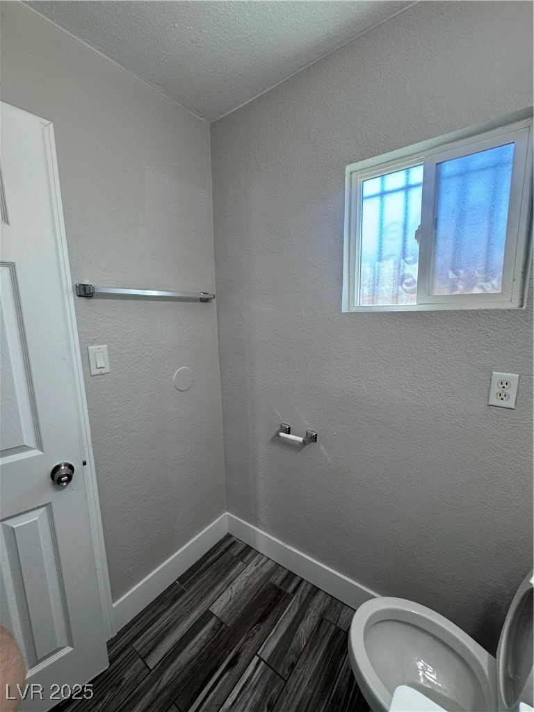 640 North 9th Street, Unit 3 Las Vegas, NV 89101 - Photo 8 of 11 Bathroom featuring a textured wall, dark wood-type flooring, and a textured ceiling