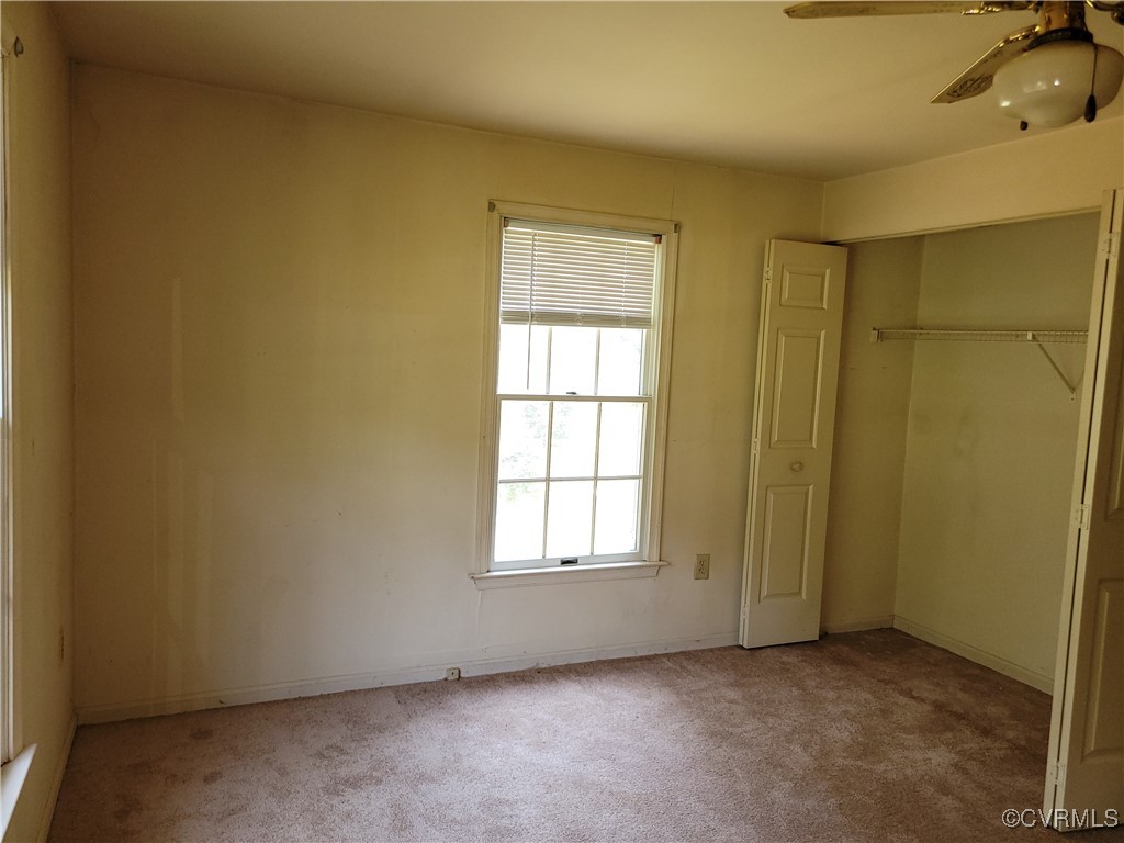 67 Lewis Road Lancaster, VA 22503 - Photo 14 of 14 Unfurnished bedroom featuring carpet and a closet