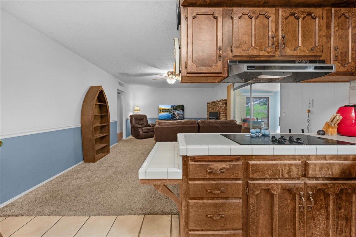 46473 Konklin Road Coarsegold, CA 93614 - Photo 14 of 38 a kitchen with kitchen island granite countertop a sink a stove and cabinets