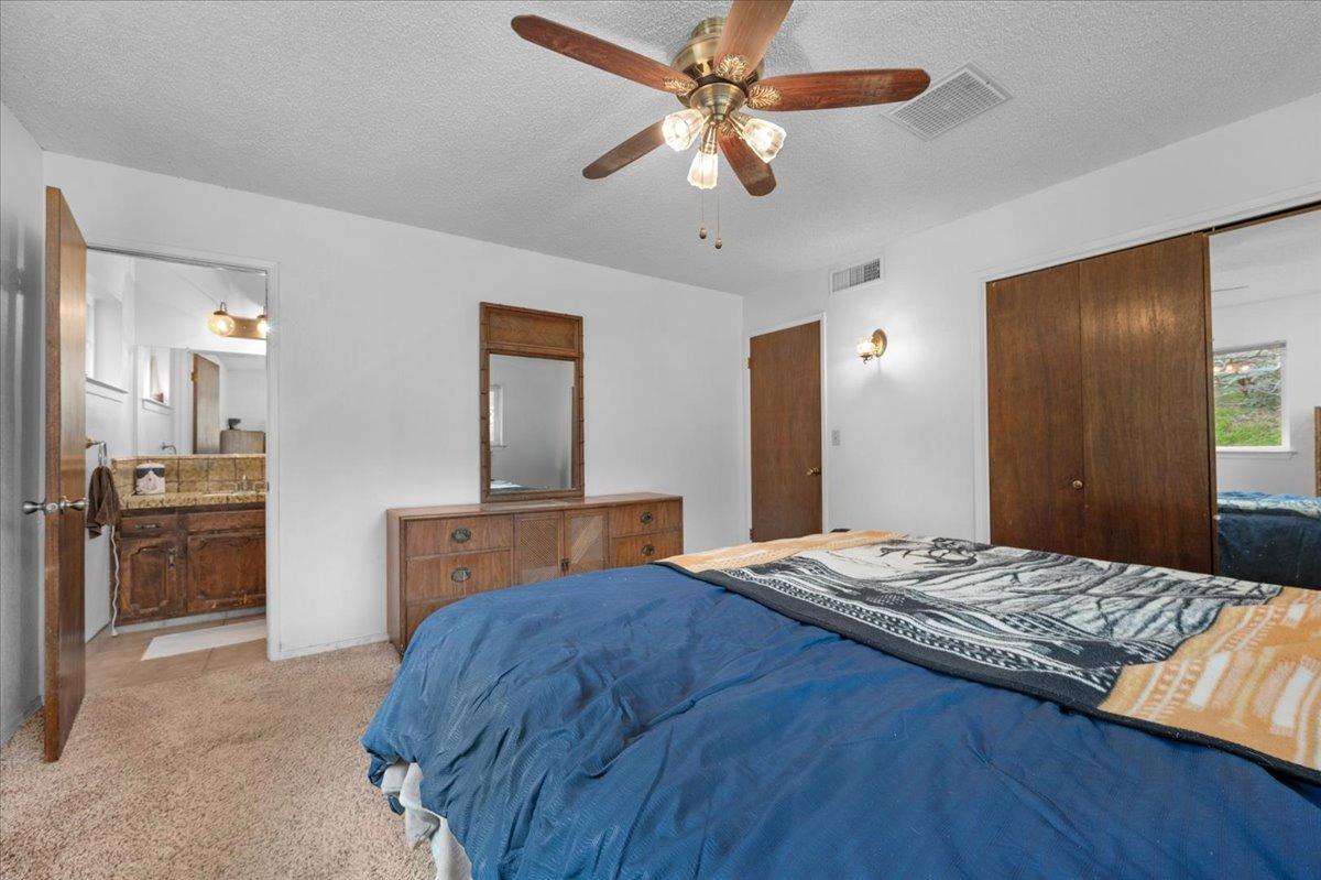 46473 Konklin Road Coarsegold, CA 93614 - Photo 21 of 38 a bedroom with a bed and a view of kitchen