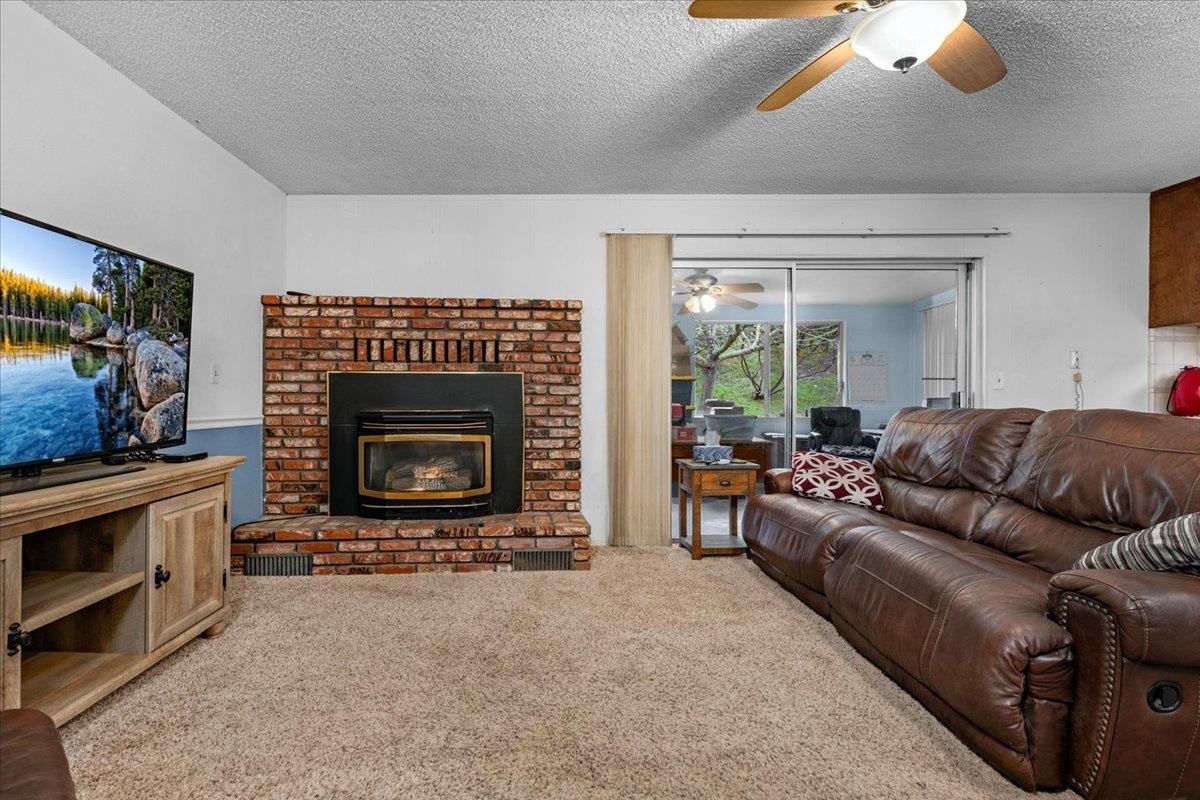 46473 Konklin Road Coarsegold, CA 93614 - Photo 10 of 38 a living room with furniture and a fireplace