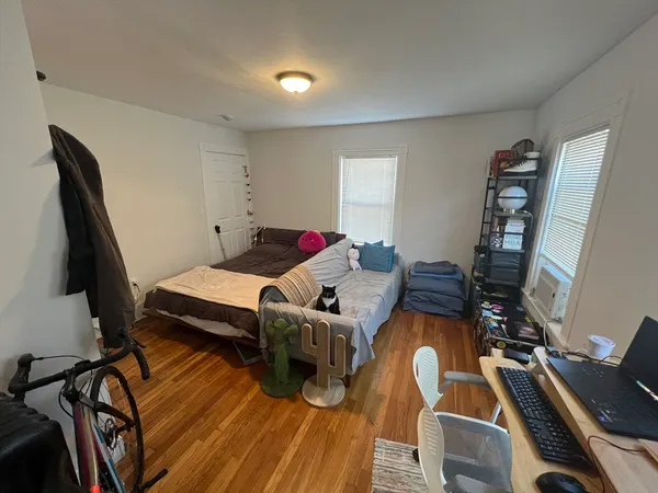a bedroom with furniture and a wooden floor
