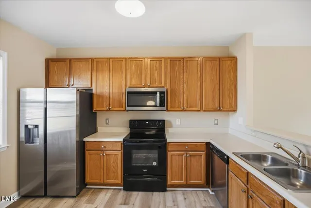 a kitchen with a refrigerator sink and microwave