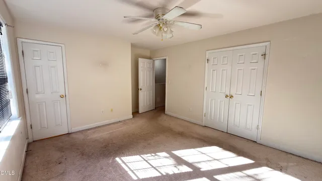 an empty room with windows and closet