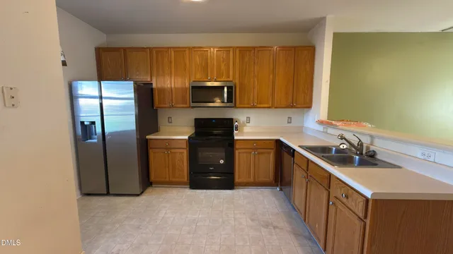 a kitchen with a refrigerator sink and microwave