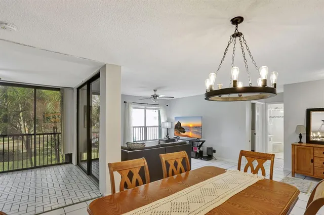 a living room with furniture a rug and a chandelier