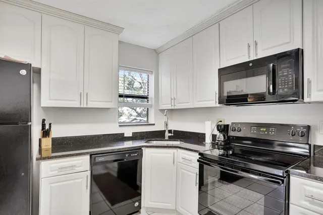 a kitchen with appliances a sink and cabinets