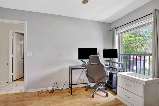 a view of a workspace with furniture and a window