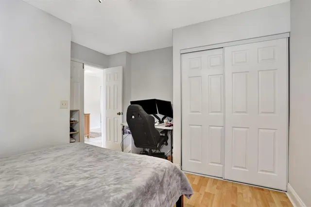 a bedroom with a bed and a chair