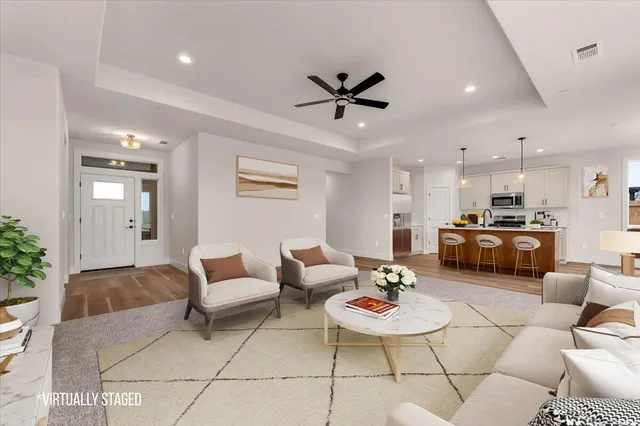 a living room with furniture and kitchen view