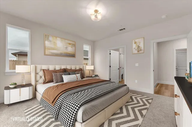 a spacious bedroom with a bed and a couch