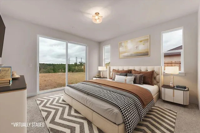 a bedroom with a bed and a large window with balcony view