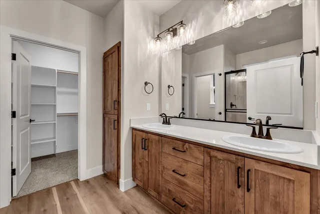 a bathroom with a double vanity sink and mirror
