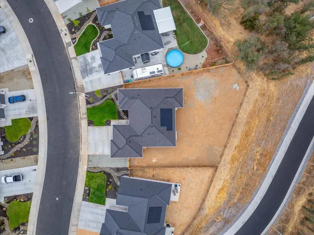 an aerial view of a house with a swimming pool