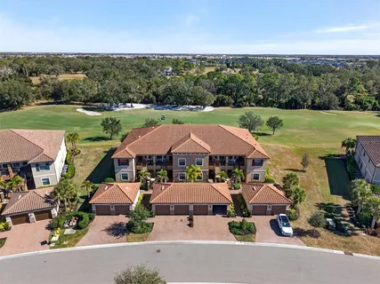an aerial view of a house with garden space and ocean view