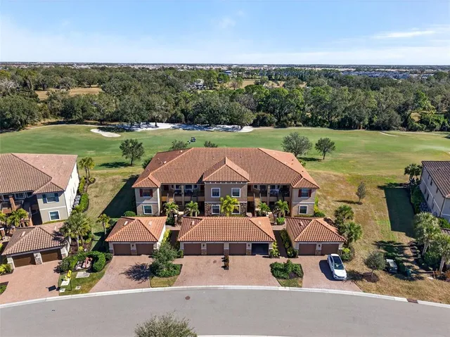 an aerial view of a house with garden space and ocean view