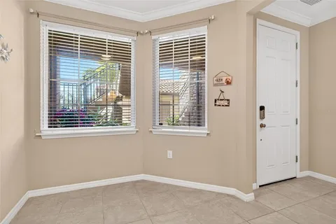 a kitchen with stainless steel appliances granite countertop a refrigerator a sink and white cabinets
