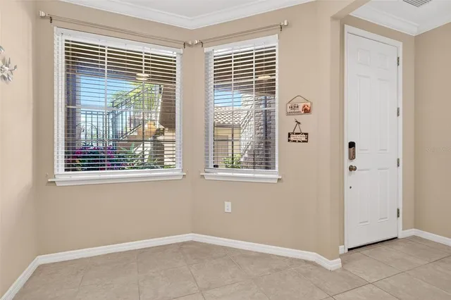 a kitchen with stainless steel appliances granite countertop a refrigerator a sink and white cabinets