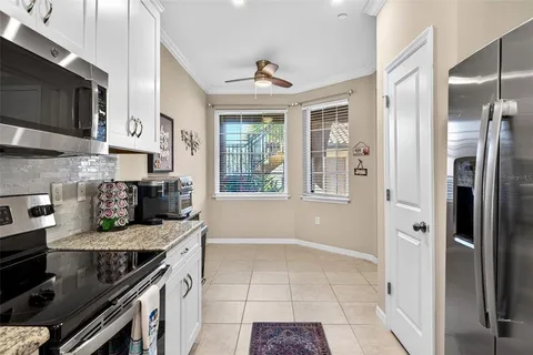 a living room with furniture a dining table and a chandelier