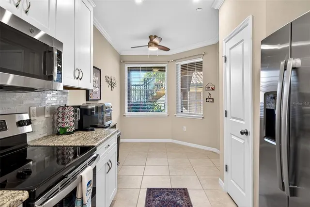a living room with furniture a dining table and a chandelier