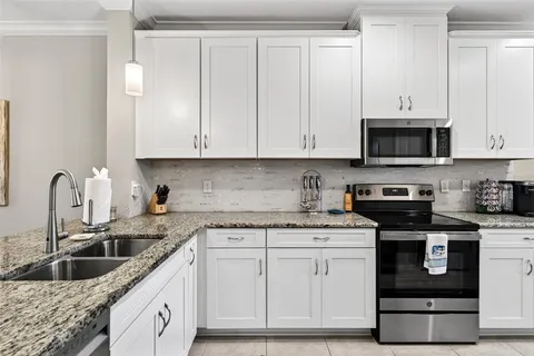a living room with furniture and a view of kitchen