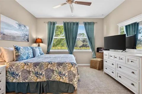 a bathroom with a granite countertop toilet sink and mirror