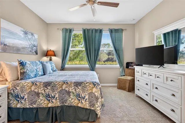 a bathroom with a granite countertop toilet sink and mirror