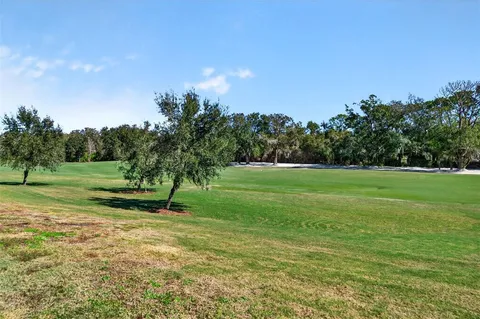 an aerial view of a residential houses with outdoor space and swimming pool