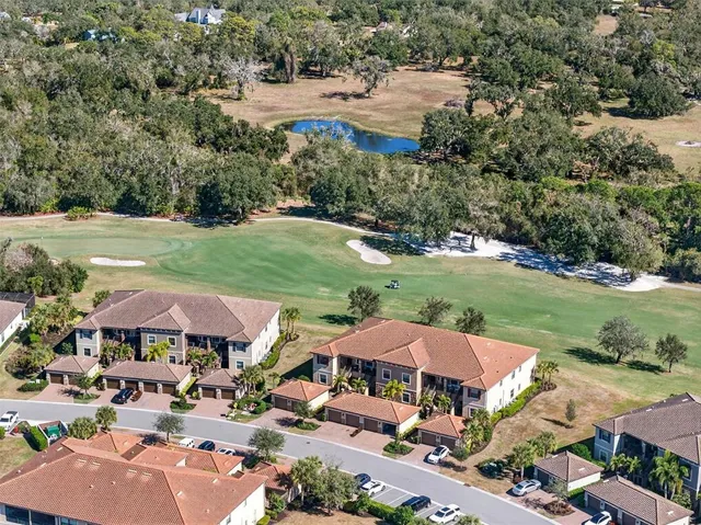 a kitchen with stainless steel appliances kitchen island granite countertop a refrigerator and a stove