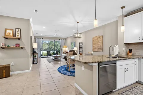 a kitchen with stainless steel appliances kitchen island granite countertop a refrigerator and a stove top oven