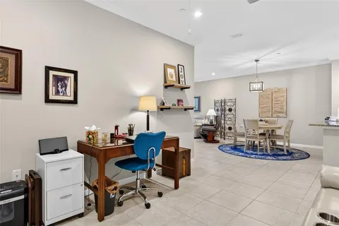 a view of a kitchen with kitchen island cabinets and refrigerator