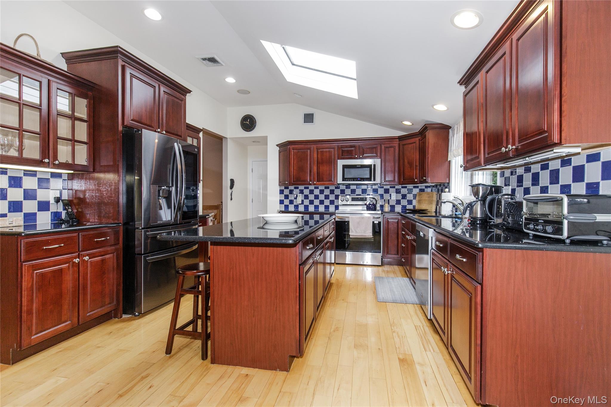 5 Searington Drive Syosset, NY 11791 - Photo 11 of 34 a kitchen with stainless steel appliances granite countertop wooden cabinets a stove top oven a sink and dishwasher