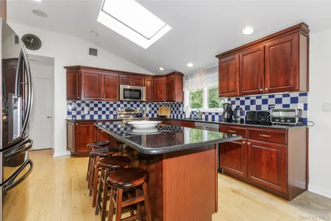 a kitchen with stainless steel appliances a sink stove and cabinets