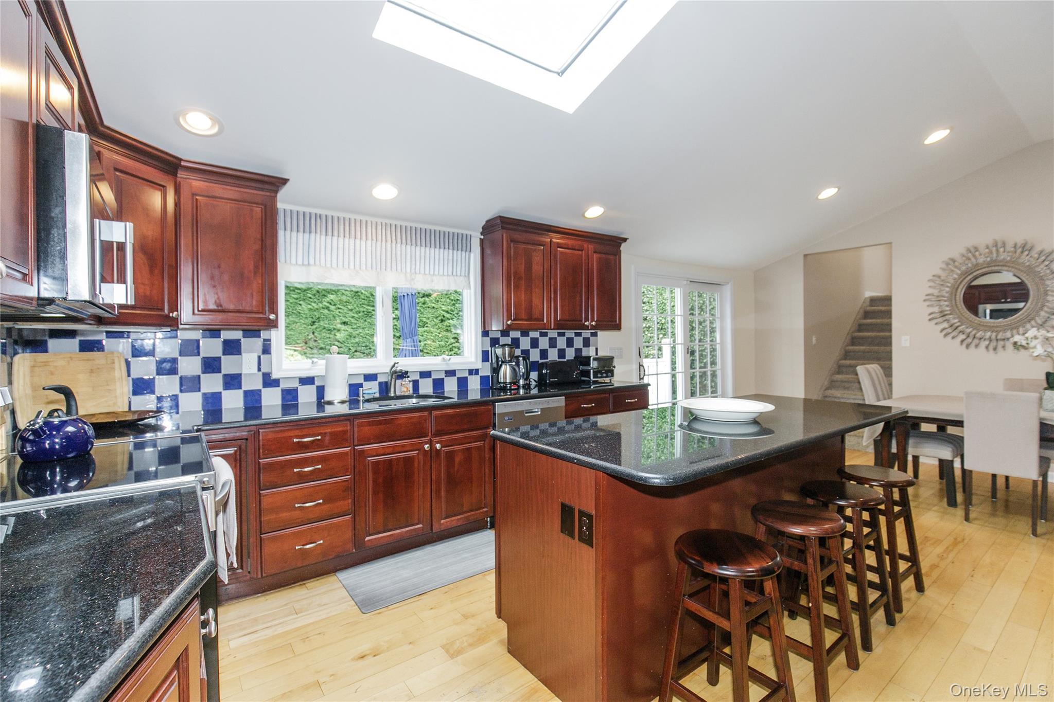 5 Searington Drive Syosset, NY 11791 - Photo 13 of 34 a kitchen with stainless steel appliances granite countertop a sink counter space cabinets and a large window