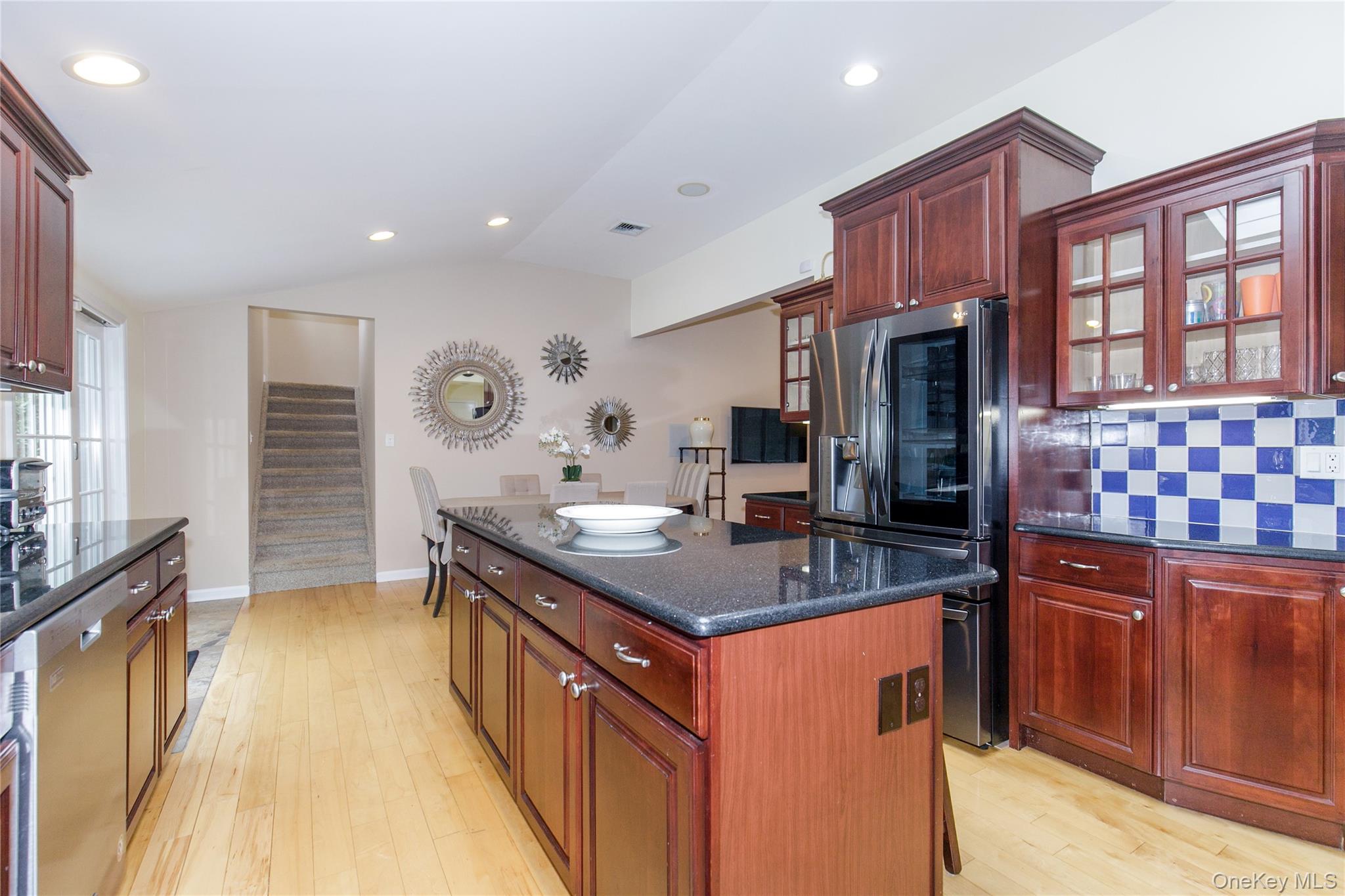 5 Searington Drive Syosset, NY 11791 - Photo 14 of 34 a kitchen with kitchen island granite countertop a sink stove and refrigerator