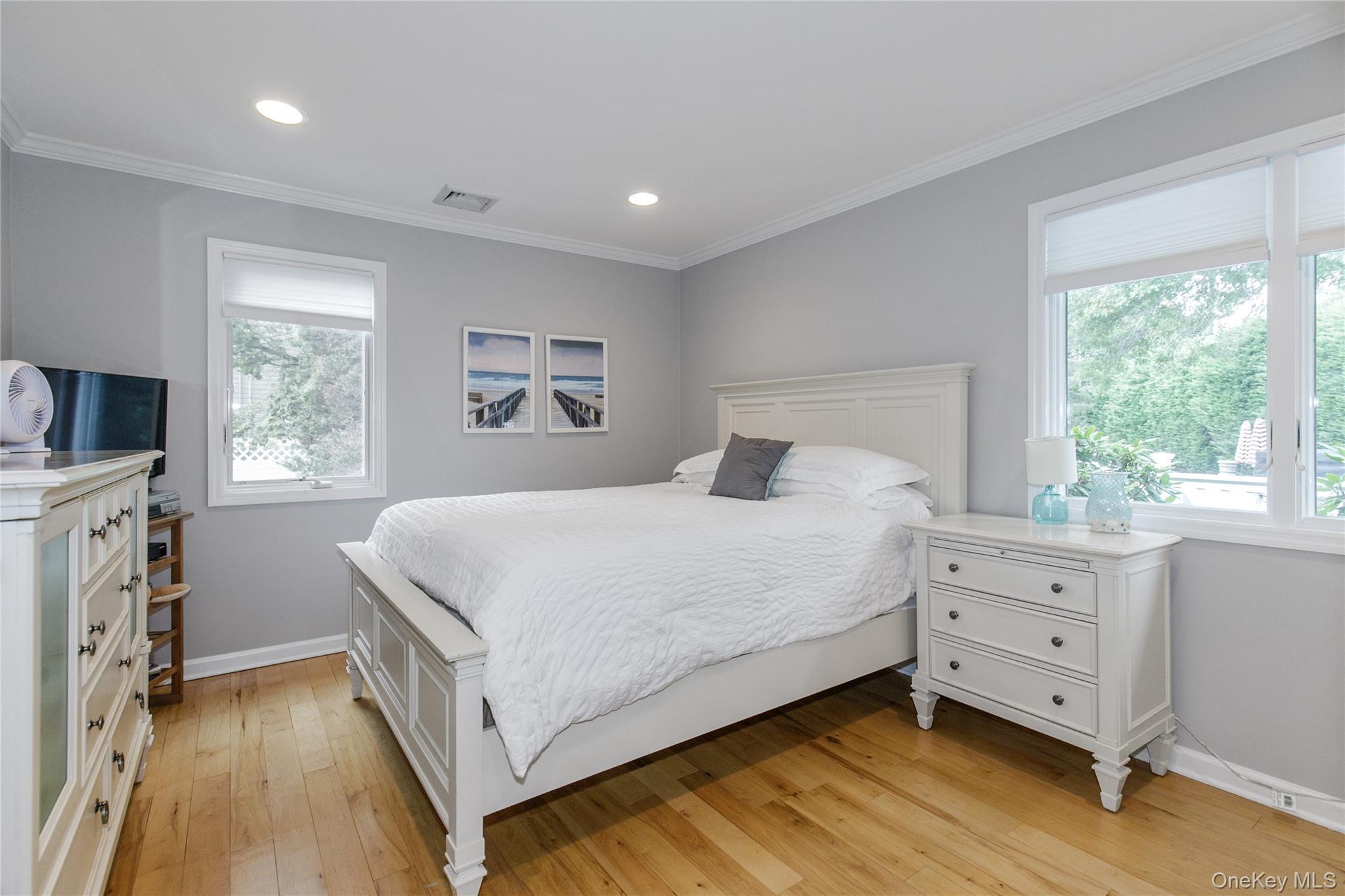 5 Searington Drive Syosset, NY 11791 - Photo 17 of 34 a bedroom with a large bed and a window
