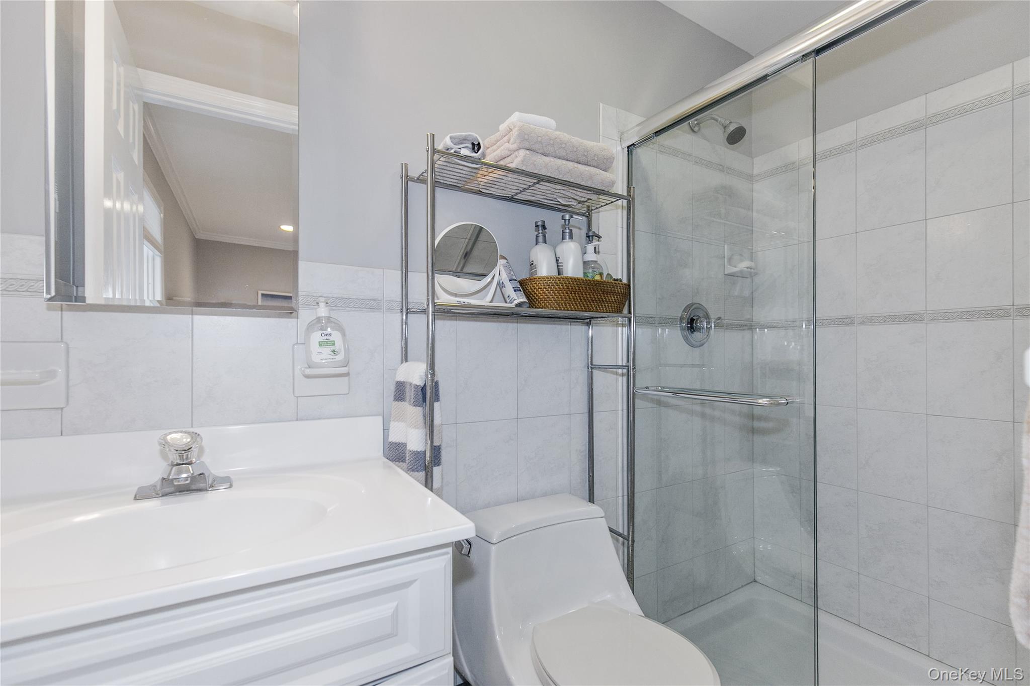 5 Searington Drive Syosset, NY 11791 - Photo 19 of 34 a bathroom with a sink toilet and shower