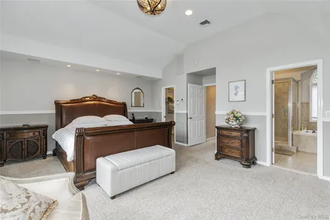 a bedroom with a bed and dresser